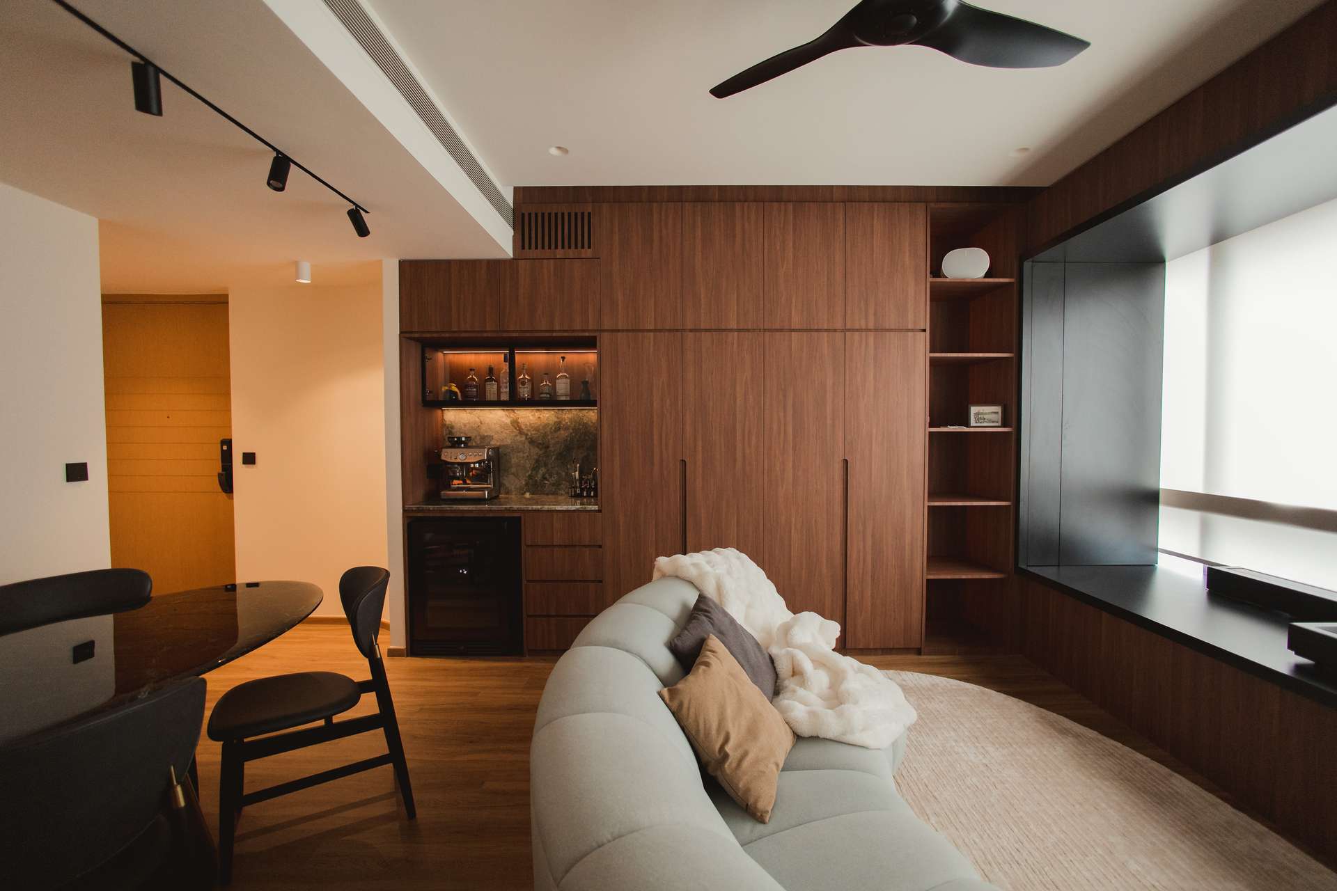 A GRITLINE interior — warm walnut joinery, ambient lighting and bespoke built-ins